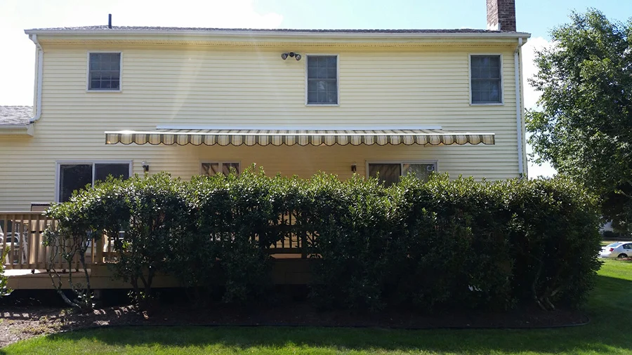 retractable awning on yellow house