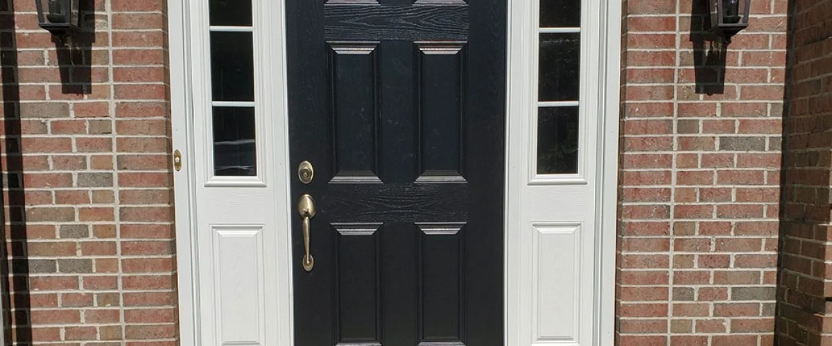 black four panel entry door with three pane side panels