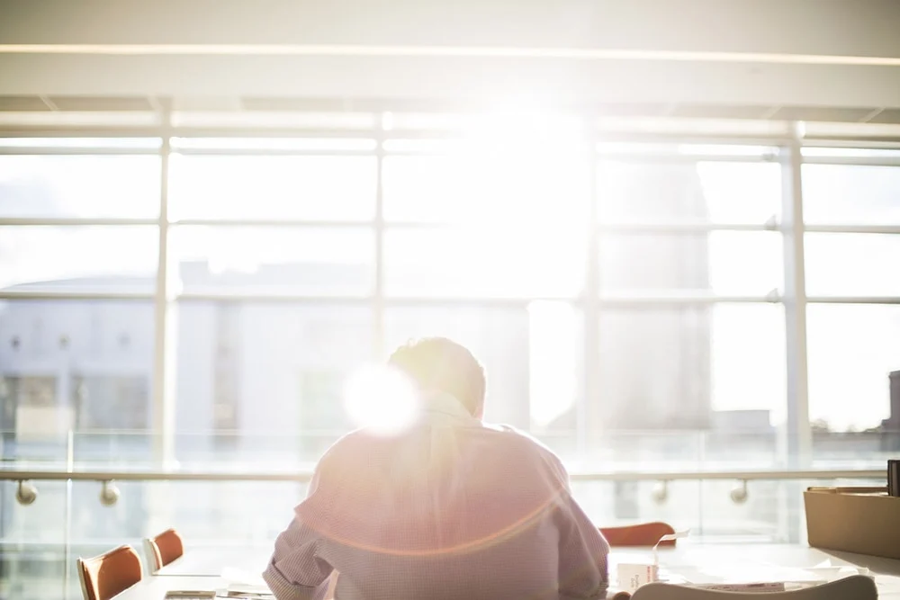 sun glaring through window onto person