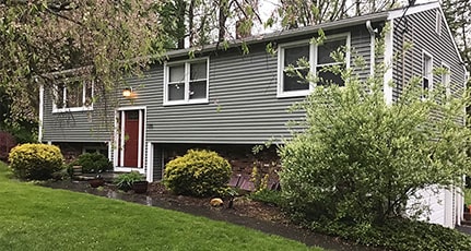 home with green vinyl siding and white trim