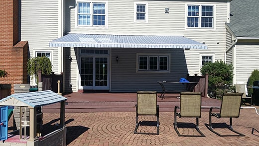 white and blue striped retractable awning