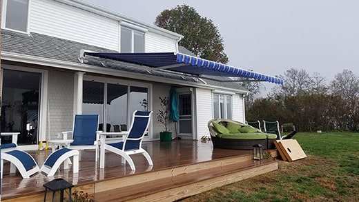 blue and white striped retractable awning