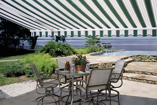 striped retractable awning covering a beach house patio