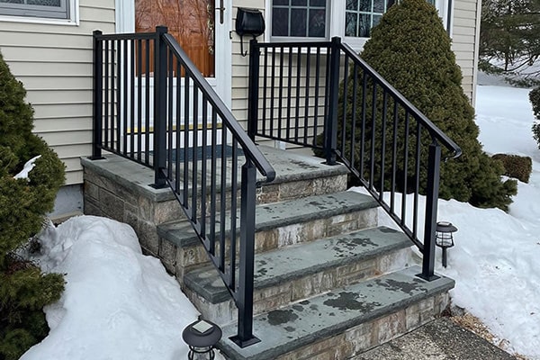 black aluminum railing installed on stone porch