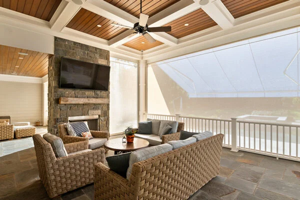 living room with television and furniture dimmed with a patio screen