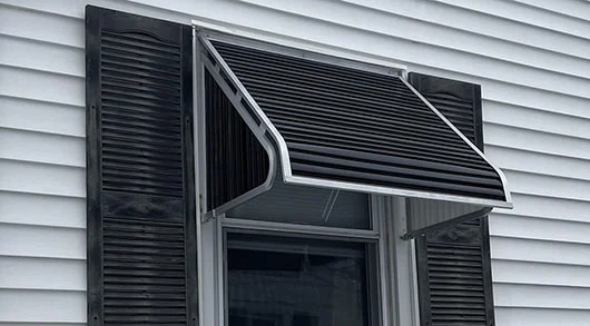 black aluminum window awning with white trim