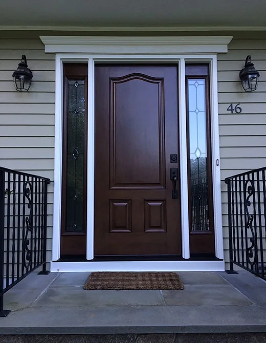 dark wood entry door with glass side panels