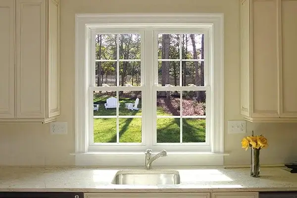 double hung windows above a sink in a kitchen