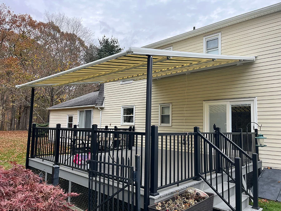 striped retractable awning covering a patio