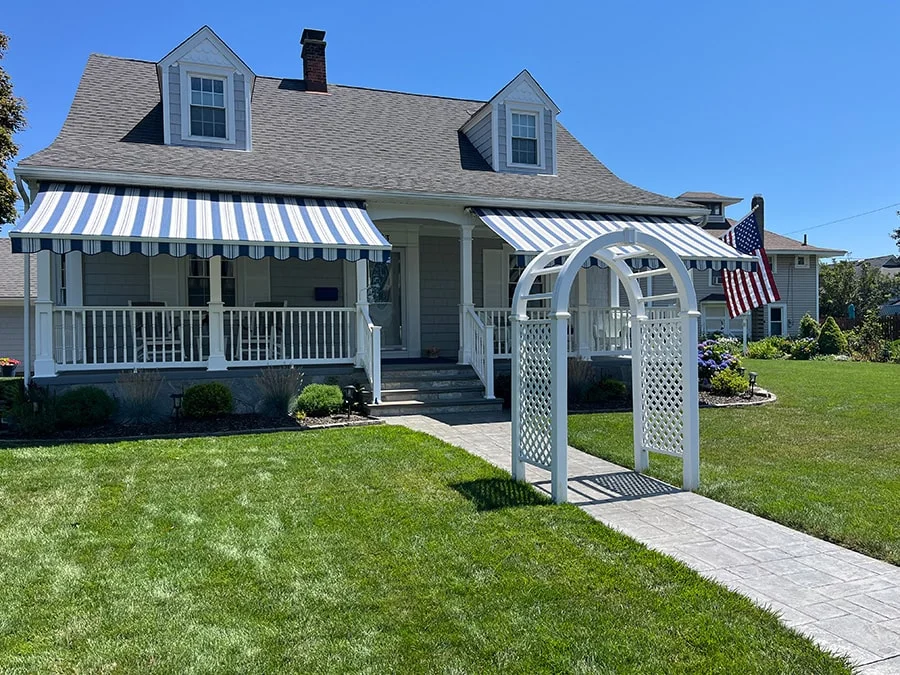 double retractable awnings over the front porch of a home