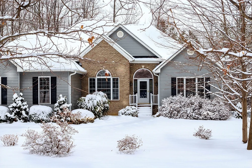 house surrounded by snow