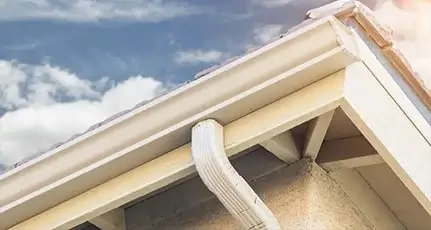 corner of roofline showing aluminum gutter and downspout