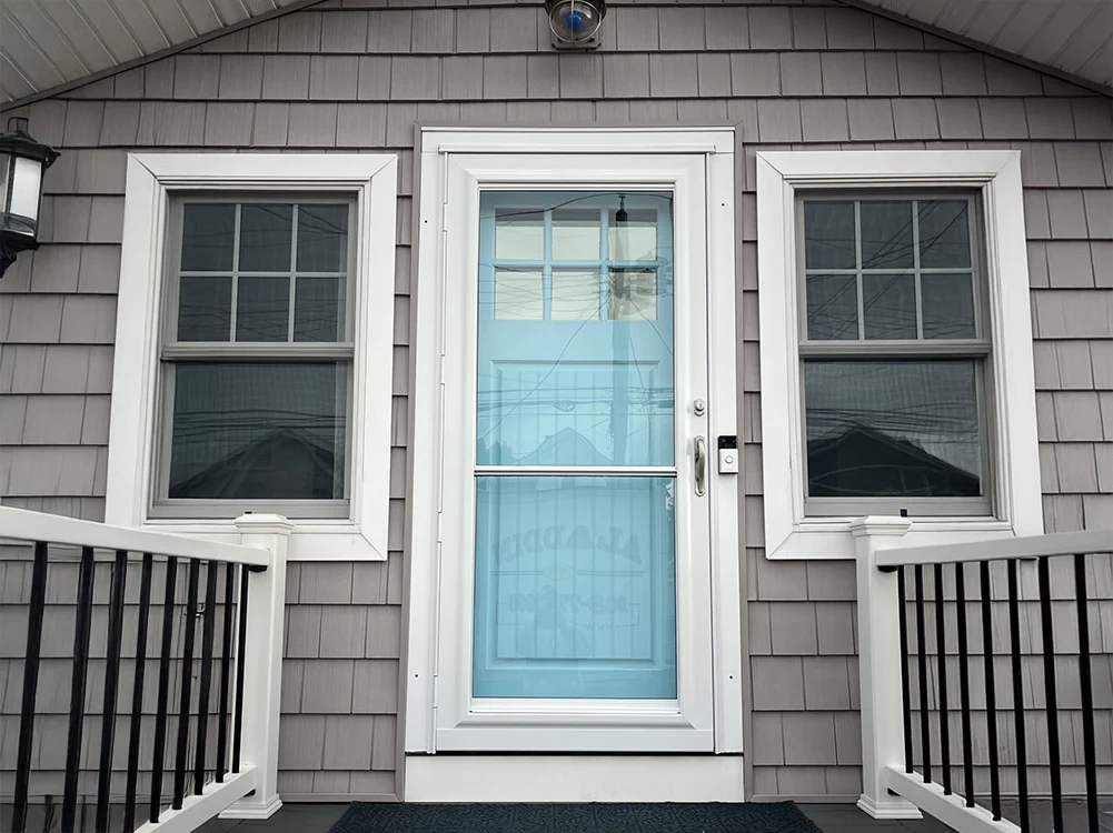 bright blue entry door behind a new storm door