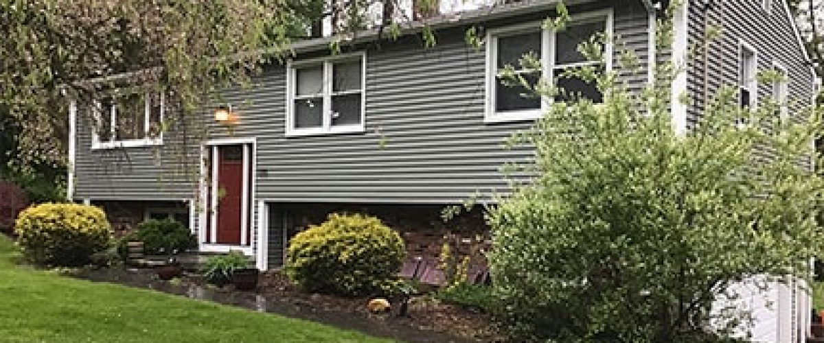 home with green vinyl siding and white trim