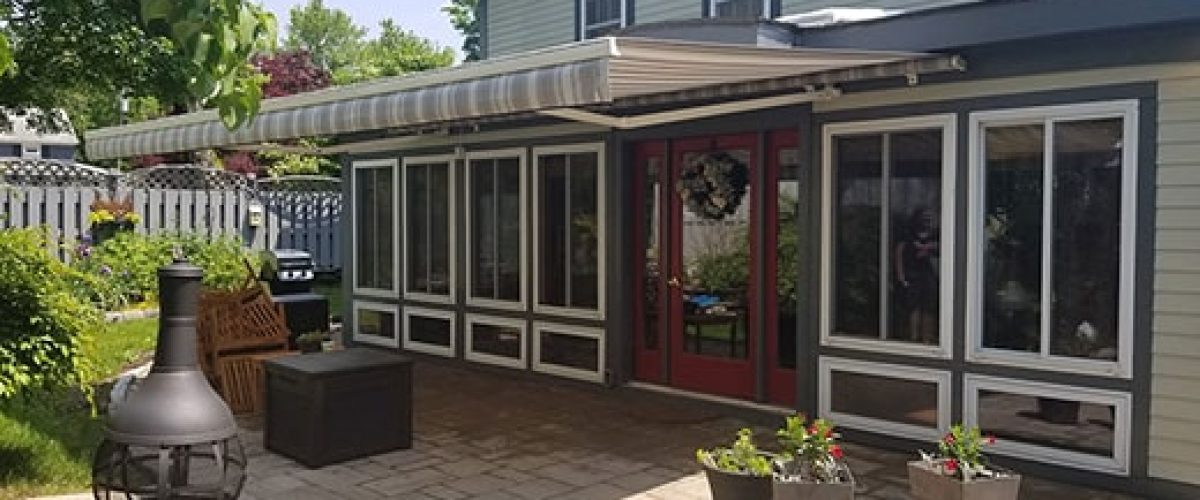 retractable awning installed on house with red door