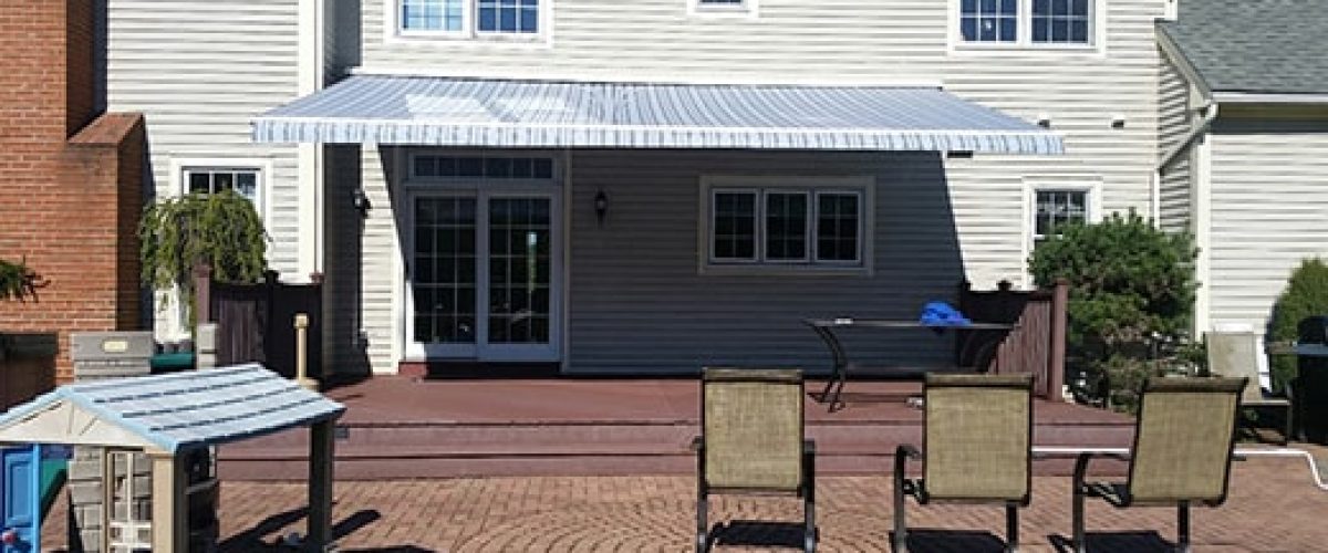 white and blue striped retractable awning