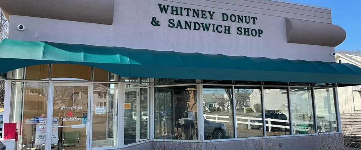 green commercial awning above a sandwich shop entryway