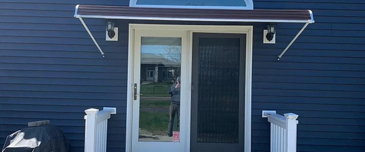 black aluminum door canopy with white trim above patio doors