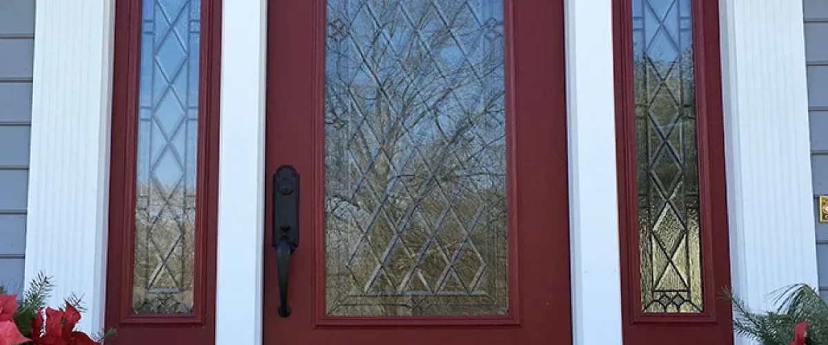 red entry door with large window and side panels