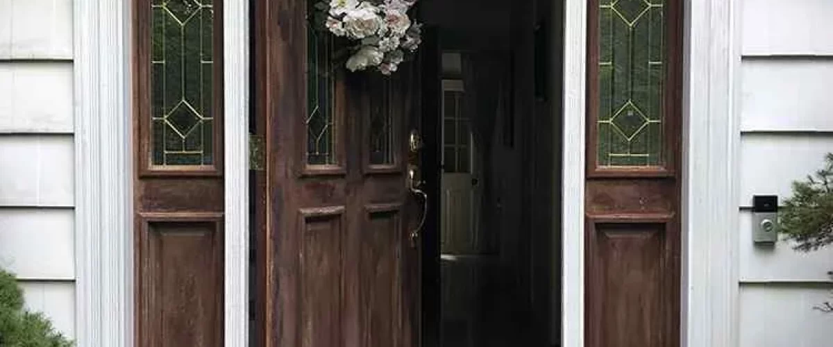 brown entry door with double window and side panels