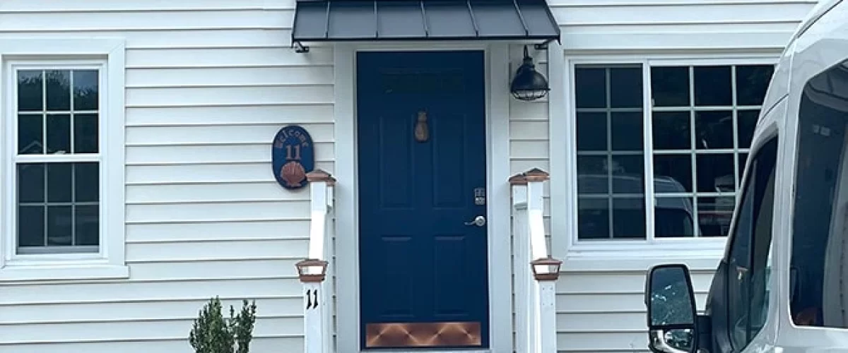 aluminum door canopy installed on a white house