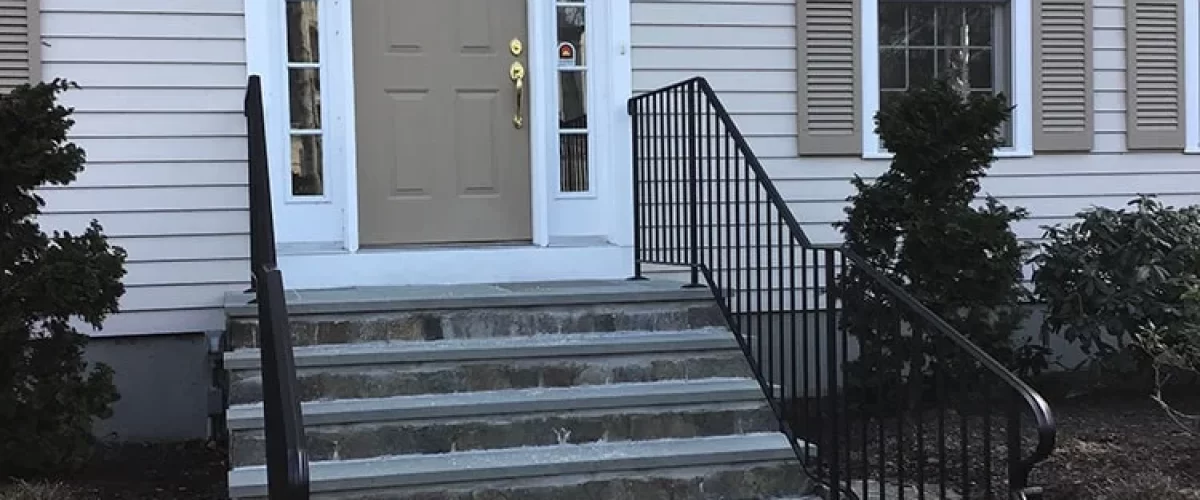 wrought iron railing on tan house