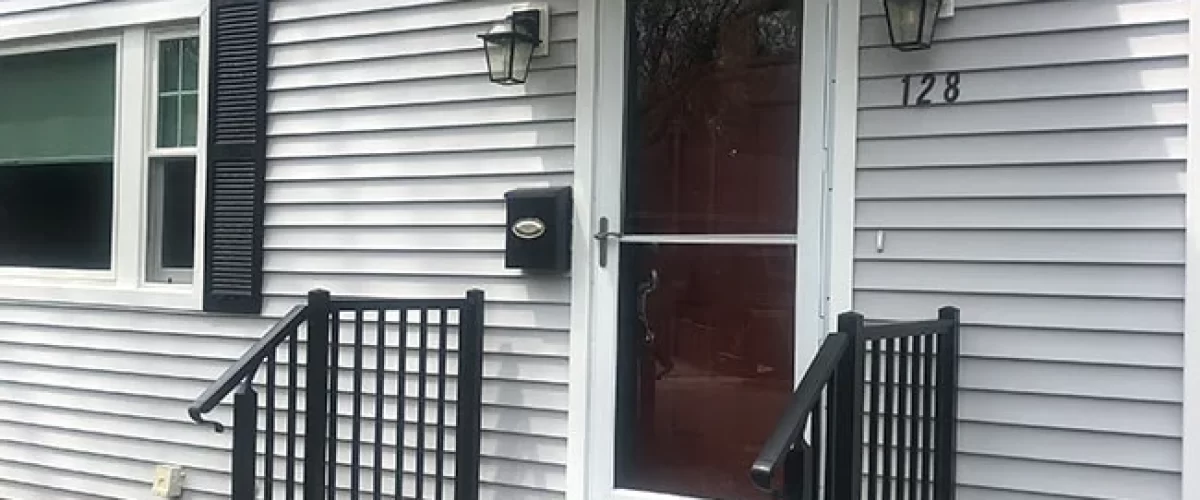 railing installed on grey house with white trim in Connecticut