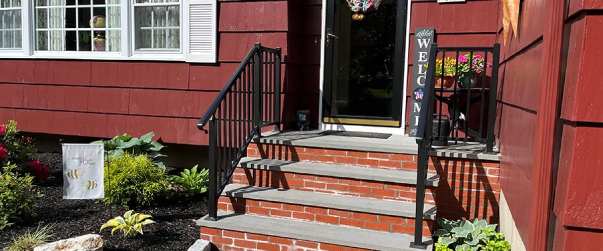 black aluminum railing installed on a red shingle tile house