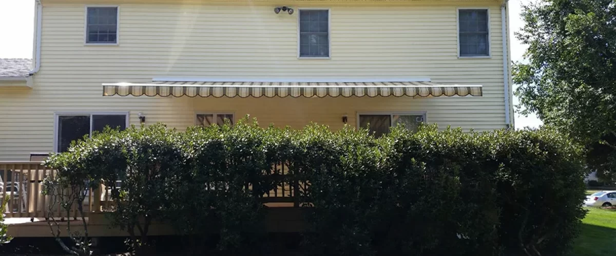 retractable awning on yellow house