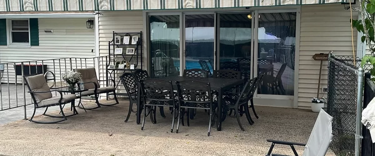 green on tan retractable awning covering patio