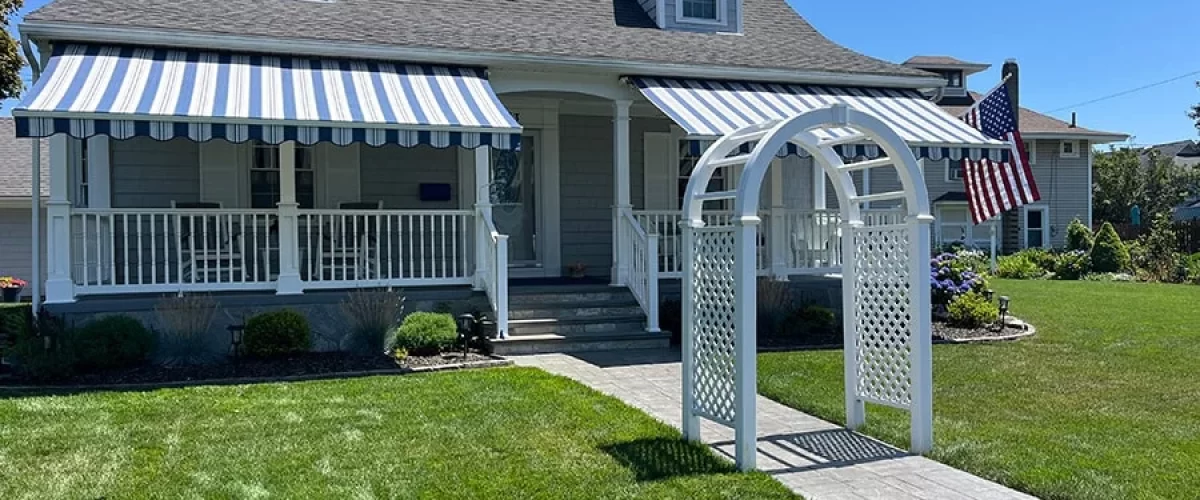 double retractable awnings over the front porch of a home