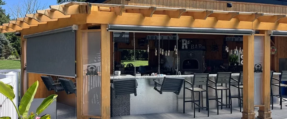 wood pergola with a orange retractable awning beside a pool