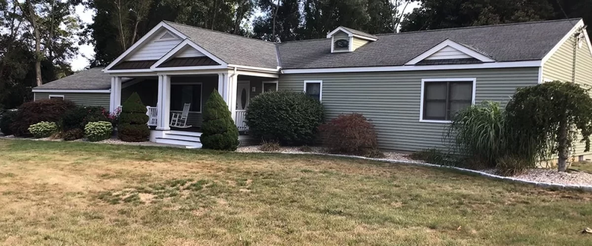 green vinyl siding installed on ranch home