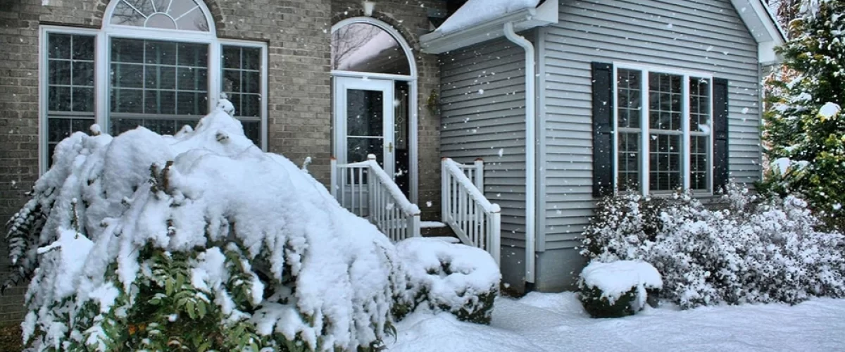 house with snow falling