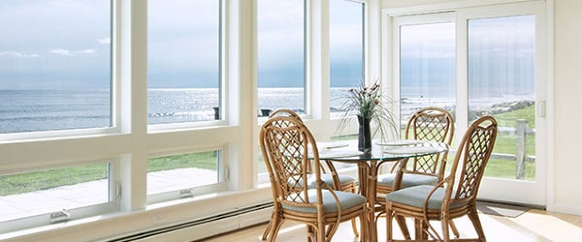 Majestic casement windows in a beige dining room