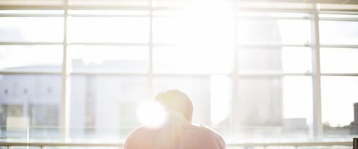 sun glaring through window onto person