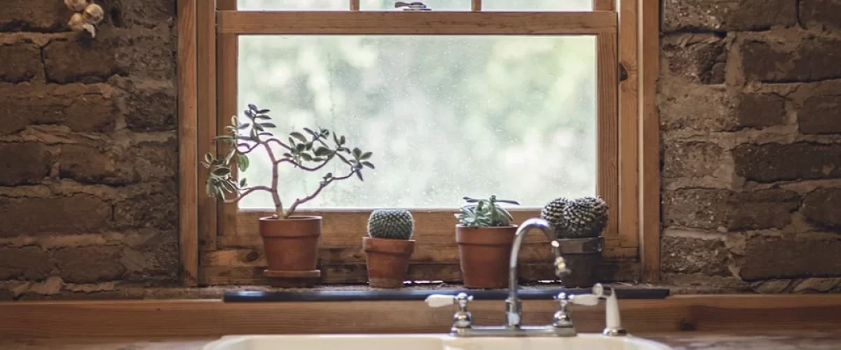 wood framed kitchen window above a sink